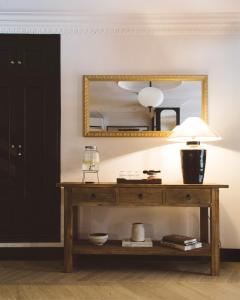 a dressing table with a mirror and a lamp at Honest Granada Hotel in Granada