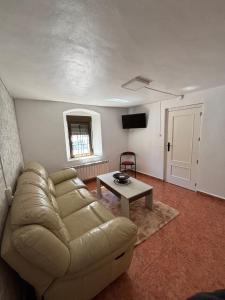 a living room with a couch and a table at Casa Rural SERAGAL in El Bonillo