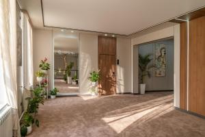 a hallway with potted plants in a building at Nord Karakol Hotel in Karakol