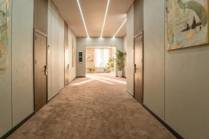 a corridor of an office with doors at Nord Karakol Hotel in Karakol