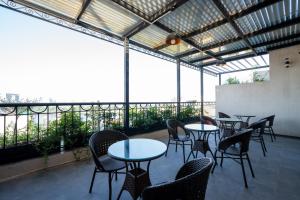 a group of tables and chairs in a room with windows at Luxe Paradise Hotel Truc Bach in Hanoi +71 photos