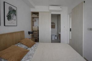 a bedroom with a large bed in a room at Skypark Celeste with stunning golf course view in Laguna Phuket