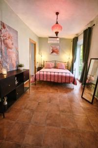 a bedroom with a bed and a large tile floor at Olé Toledo in Cómpeta