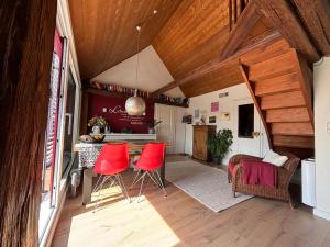 a kitchen with red chairs and a table in a room at Historische Ferienwohnung mit Sauna und Dachterrasse in Lich