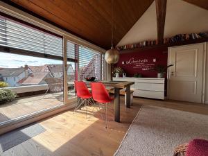 a kitchen with a table and chairs and a large window at Historische Ferienwohnung mit Sauna und Dachterrasse in Lich
