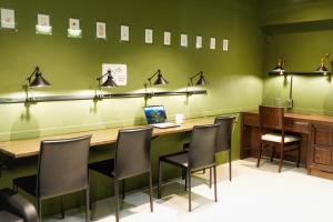 a conference room with a table and chairs and a laptop at MATSUMOTO CASTLE hostel in Matsumoto