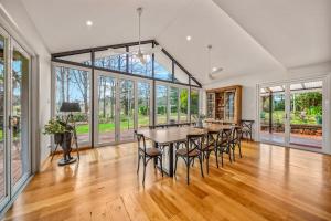 a dining room with a table and chairs at Three Pines on Grange in Porepunkah