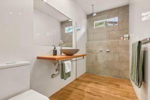 a bathroom with a sink and a mirror at Three Pines on Grange in Porepunkah +12 photos