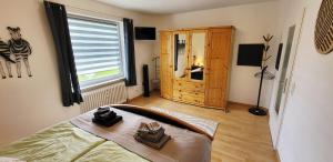 a bedroom with a bed and a large window at Birkenhain in Geltorf
