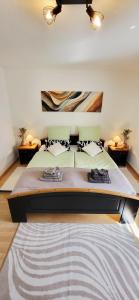 a large bed in a bedroom with two tables at Birkenhain in Geltorf