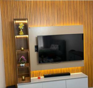 a large flat screen tv on a wall at Pinecourt Luxury Apartment in Ikate