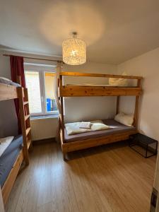 a room with two bunk beds and a chandelier at Ferienhaus-Saale-Unstrut in Wethau