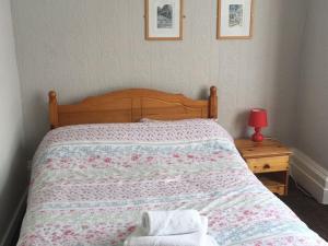 a bedroom with a bed with a wooden head board at Richmond House Hotel in Southport +8 photos
