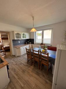 a kitchen and dining room with a table and chairs at Ferienhaus-Saale-Unstrut in Wethau