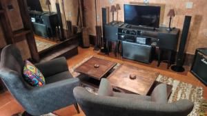 a living room with two chairs and a television at Antic house in Agadir