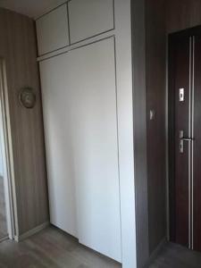 a large white wall in a room with a door at Mieszkanie BLOK in Złotów