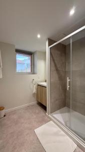 a bathroom with a shower and a sink at La petite maison orange in Koenigsmacker