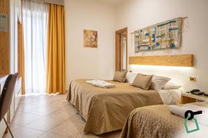 a hotel room with two beds in a room at Hotiday Gallipoli Centro in Gallipoli
