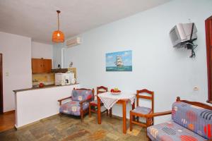a living room with a table and chairs and a kitchen at Kastri in Panormos Skopelos