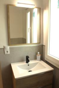 a bathroom with a sink and a mirror at Chouciña Apartments in Sanxenxo +14 photos