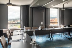 a conference room with tables and chairs and windows at Hotel SB Plaza Europa in Hospitalet de Llobregat