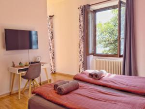 a bedroom with two beds and a desk and a window at Villa Angelina - Lake View Dreams in Cannero Riviera +141 photos