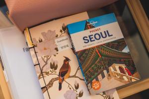 two books sitting on top of a shelf at Cozy 2 6 Guest Stay near Gangnam 6 min from Nakseongdae Station in Samgong +15 photos