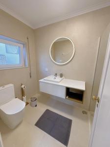 a bathroom with a white toilet and a mirror at Bay Golf House in Cascais +55 photos