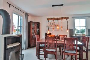 a kitchen and dining room with a table and chairs at FH Seeschwalbe in Niendorf