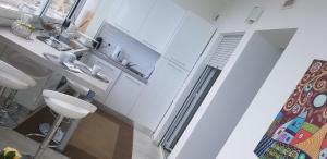a white bathroom with a sink and a toilet at CasAmare in Montesilvano