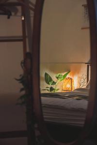 a mirror reflection of a bed with a lamp on it at Cozy 2 6 Guest Stay near Gangnam 6 min from Nakseongdae Station in Samgong