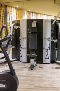 a gym with a row of exercise equipment at Hotel SB Plaza Europa in Hospitalet de Llobregat