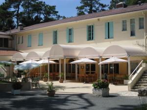 a large building with umbrellas in front of it at Les Buissonnets in Saint-Georges-de-Didonne