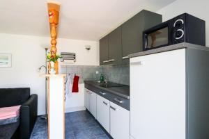 a kitchen with a tv on top of a refrigerator at Bungalow Wolfgang in Kühlungsborn +9 photos