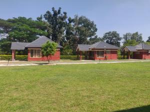 a row of red houses in a park at Dubare Inn Coorg in Siddapur