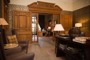 a living room with a couch and a table with lamps at One Devonshire Gardens a Hotel Du Vin in Glasgow