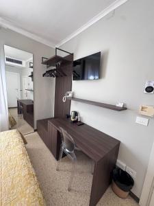 a room with a desk and a chair in a room at Hotel Adriatico in Venice