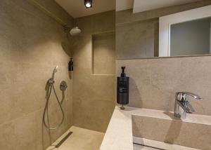a bathroom with a shower and a sink at Four Side Hotel in Prishtinë +69 photos