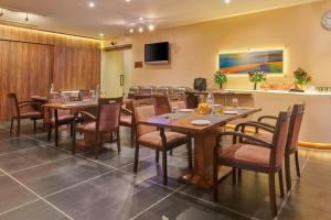 a large dining room with tables and chairs at Hotel Studio Estique in Pune