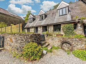 an old stone house with a stone wall at 2 Bed in Llandovery oc-bn094 in Llandovery