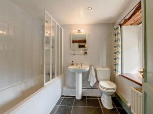 a bathroom with a white toilet and a sink at 2 Bed in Llandovery oc-bn094 in Llandovery +22 photos
