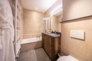 a bathroom with a toilet and a sink and a tub at La Barrière de Transinne in Libin +53 photos