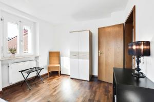 a white room with a desk and a chair at Ferienwohnung Südschwarzwald in Wehr
