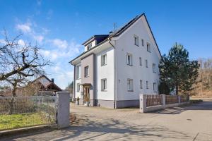 a white house with a fence in front of it at Ferienwohnung Südschwarzwald in Wehr