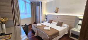 a hotel room with a bed and a desk at Hotel Nueva Plaza in Maliaño +145 photos