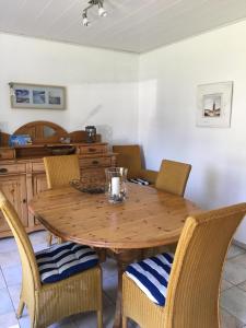 a wooden table in a kitchen with chairs around it at Ferienhaus Familie Lehmann in Borkum