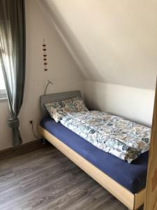 a bed with a blue mattress in a room at Ferienhaus Familie Lehmann in Borkum