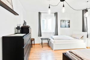 a bedroom with a bed and a dresser in a room at Ferienwohnung Südschwarzwald in Wehr