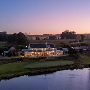 an aerial view of a house with a pond at Gowrie Farm Golf Lodge in Nottingham Road