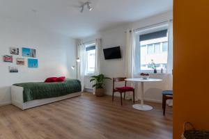 a bedroom with a bed and a table in it at Jotica Colonia in Cologne